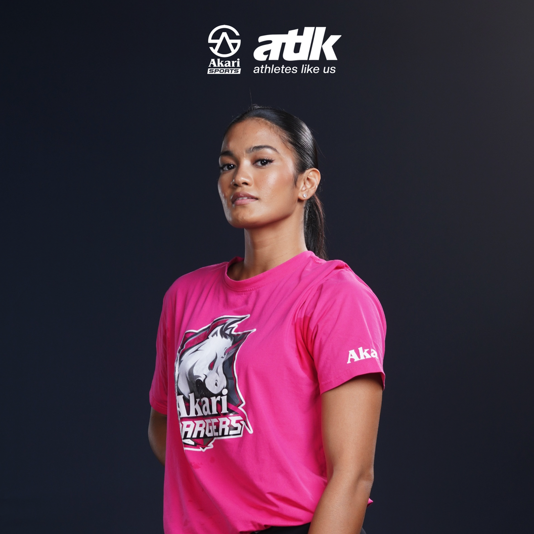 Player wearing a magenta 'Akari' t-shirt with a dark background and brand logo.